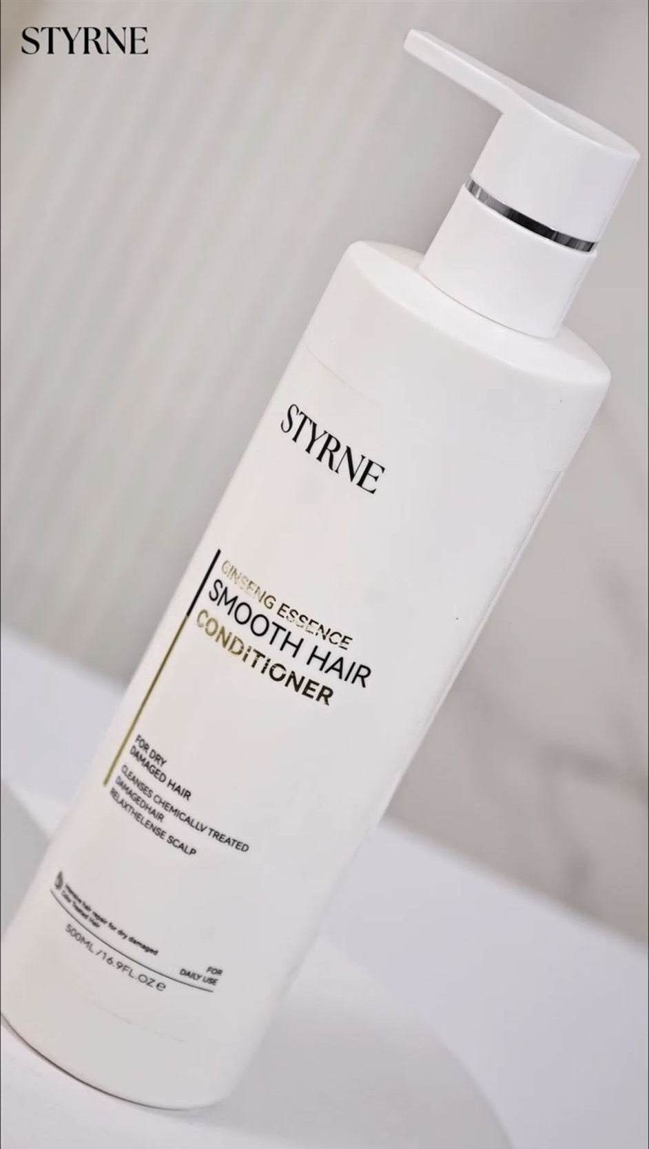 White Styrne Hair conditioner bottle with cream background