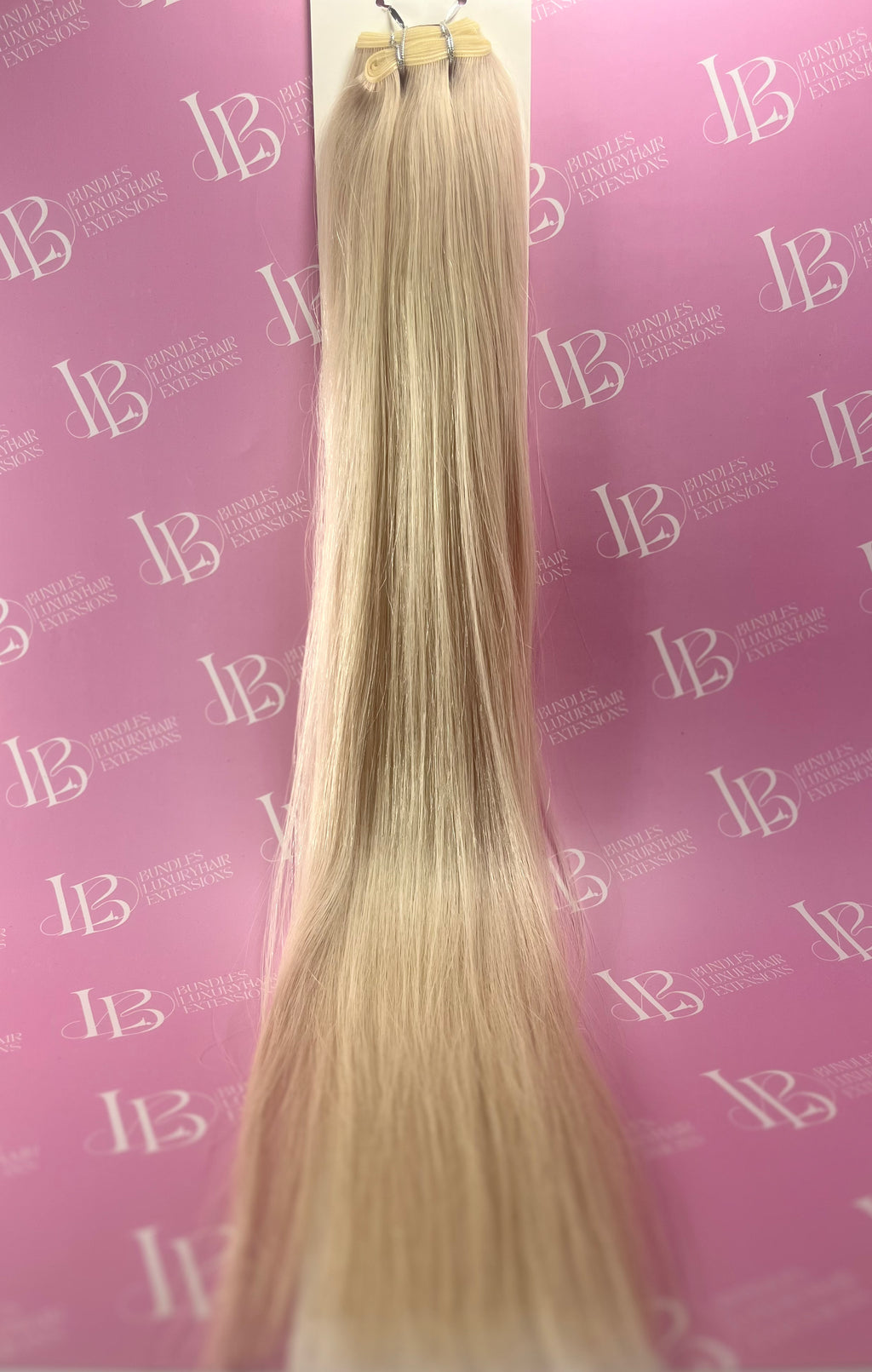 Blonde hair extensions on a pink background with 'LB' branding.
